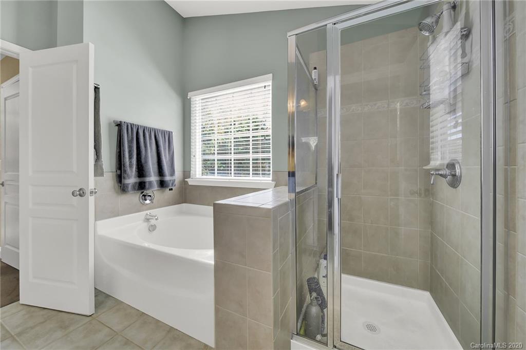 320 Sand Paver Way Fort Mill, SC 29708 - Photo 24 of 42 a bathroom with a tub a sink and a shower