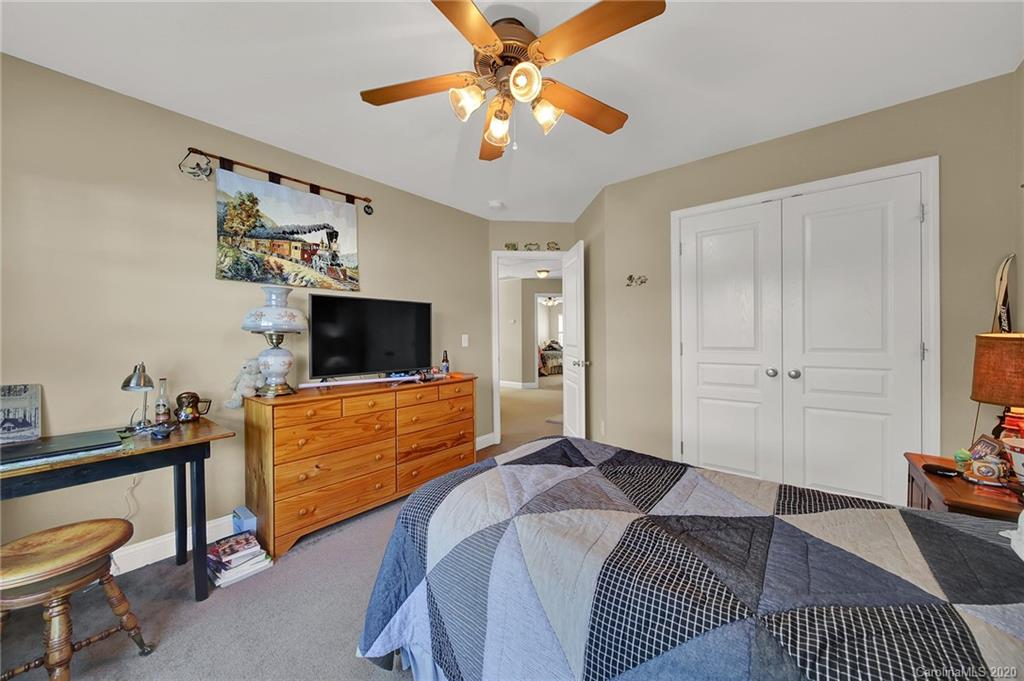 320 Sand Paver Way Fort Mill, SC 29708 - Photo 26 of 42 a bedroom with a bed and a flat screen tv