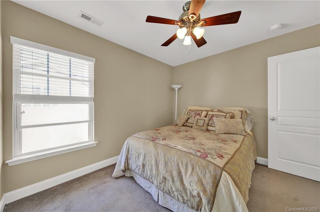 320 Sand Paver Way Fort Mill, SC 29708 - Photo 31 of 42 a bedroom with a bed chandelier and a window