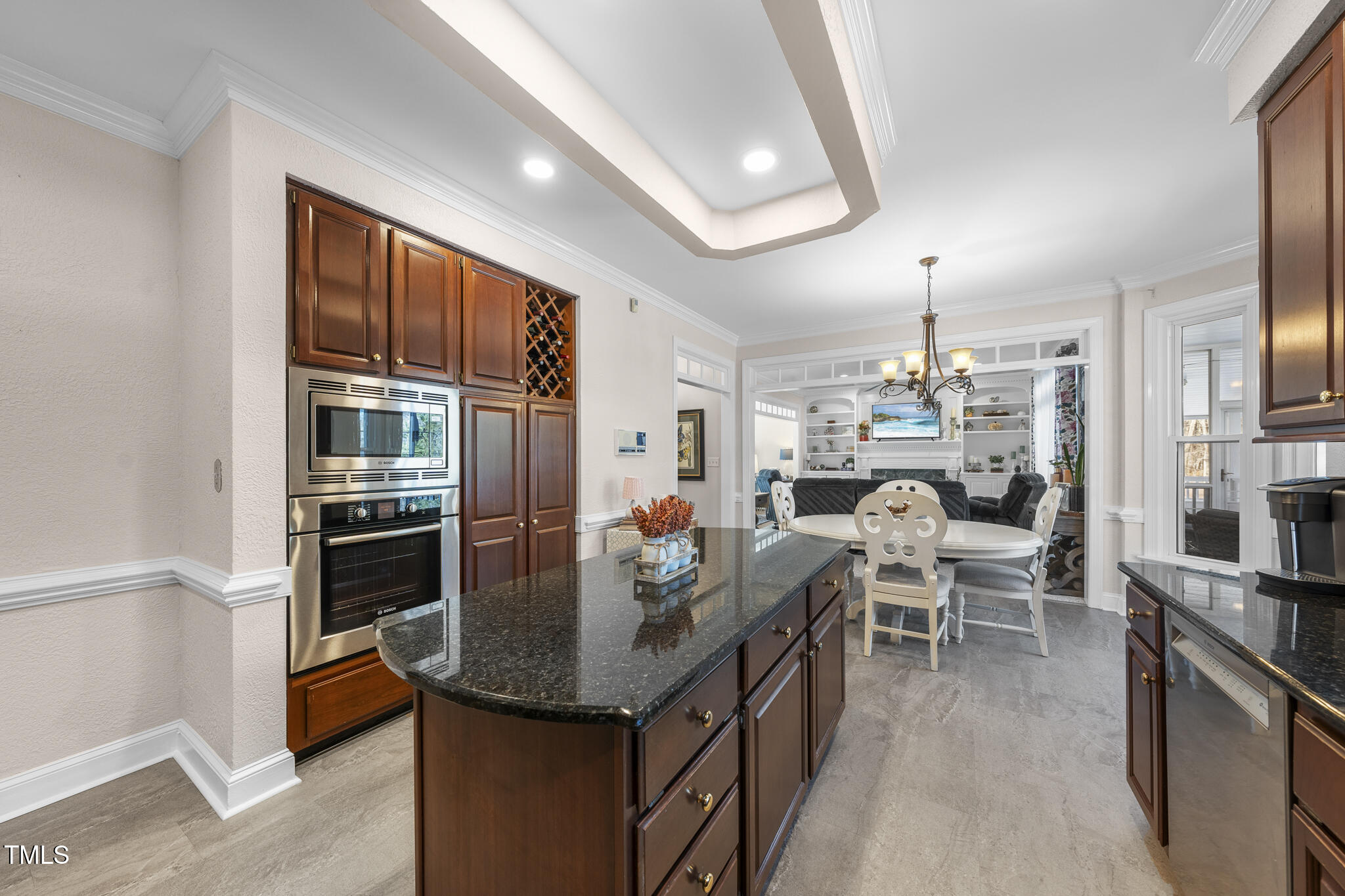 12016 Pembridge Lane Raleigh, NC 27613 - Photo 15 of 52 a kitchen with stainless steel appliances kitchen island granite countertop a table chairs in it and a window