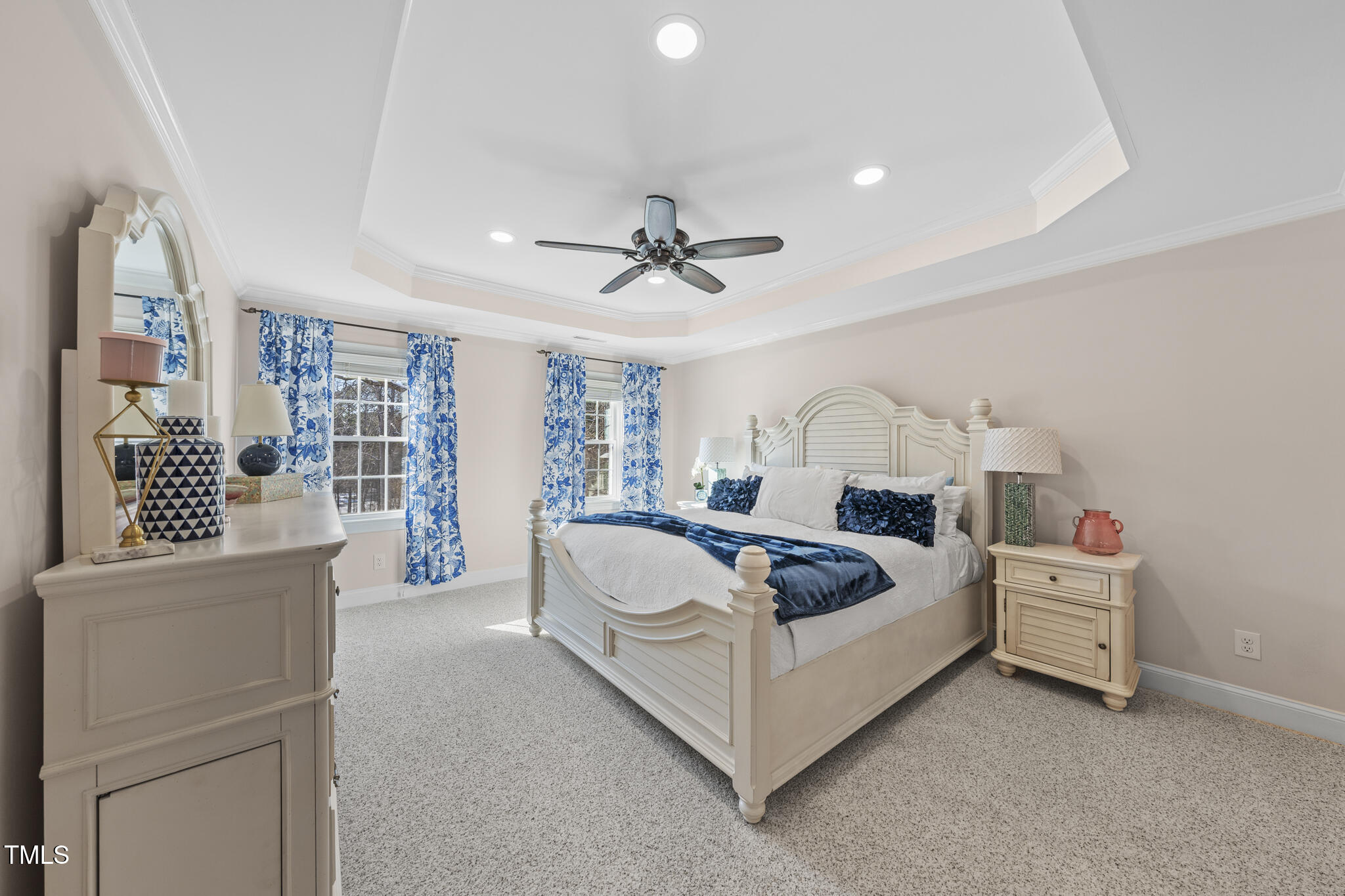 12016 Pembridge Lane Raleigh, NC 27613 - Photo 18 of 52 a spacious bedroom with a bed a window and a chandelier