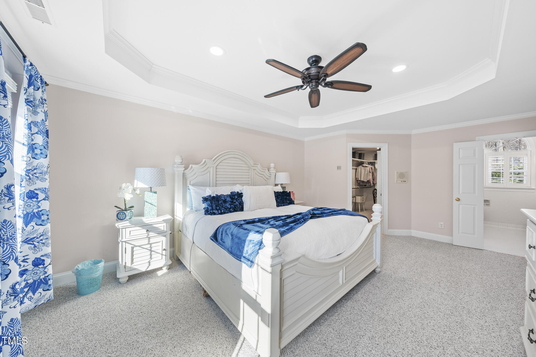 12016 Pembridge Lane Raleigh, NC 27613 - Photo 20 of 52 a bedroom with a bed and a chandelier