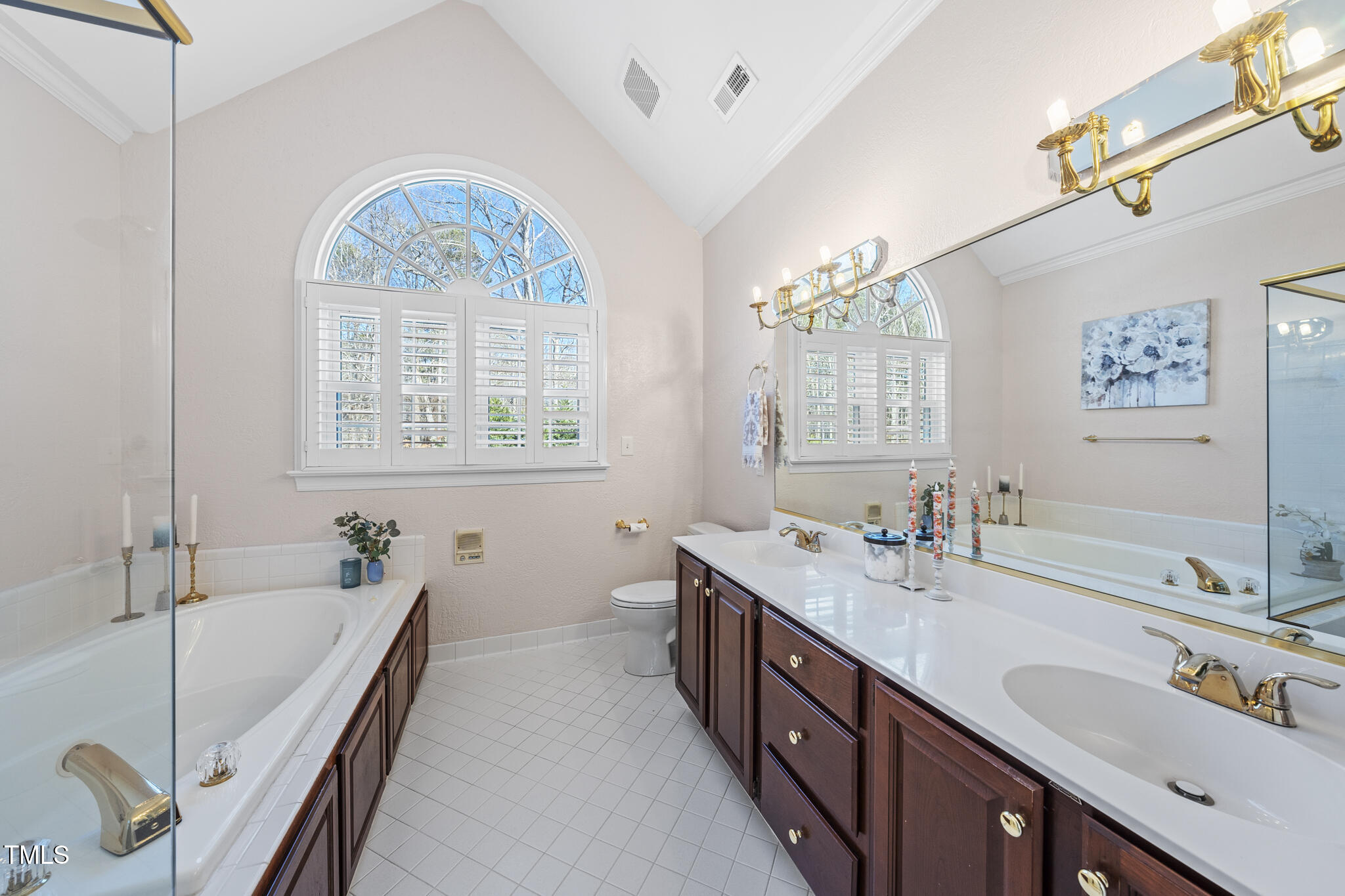 12016 Pembridge Lane Raleigh, NC 27613 - Photo 21 of 52 a spacious bathroom with a tub double sink window and mirror