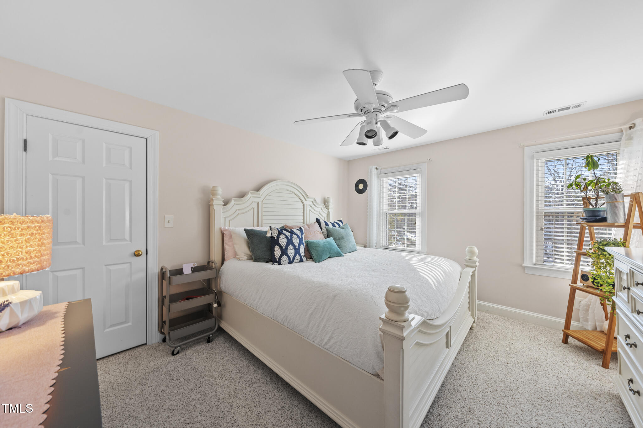 12016 Pembridge Lane Raleigh, NC 27613 - Photo 26 of 52 a bedroom with a bed and a chandelier
