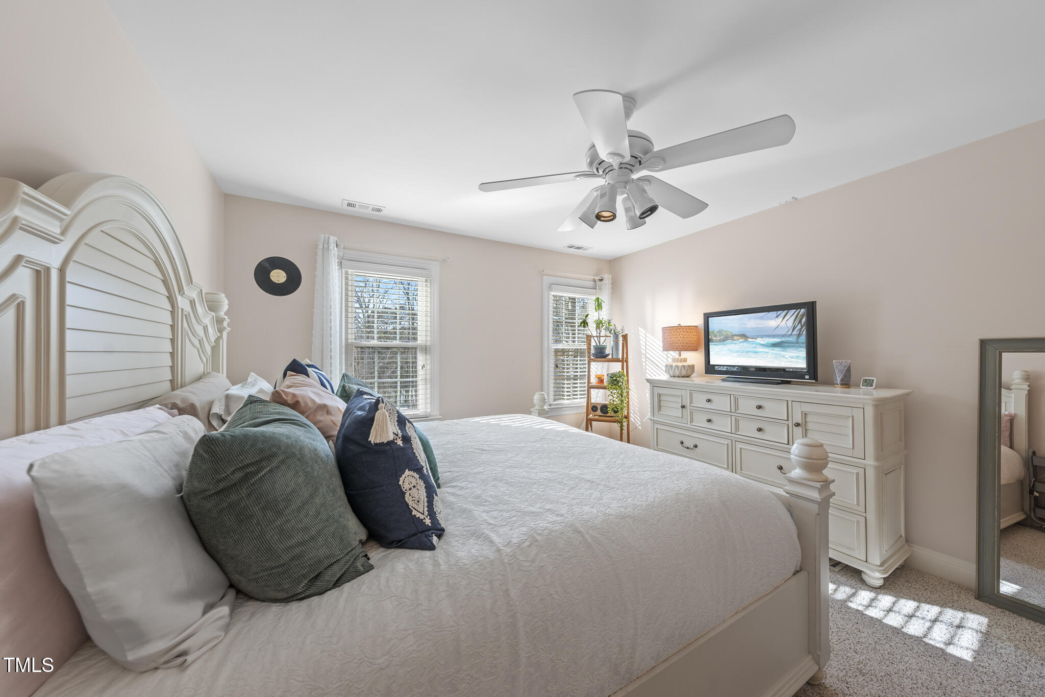 12016 Pembridge Lane Raleigh, NC 27613 - Photo 27 of 52 a bedroom with a bed and a chandelier