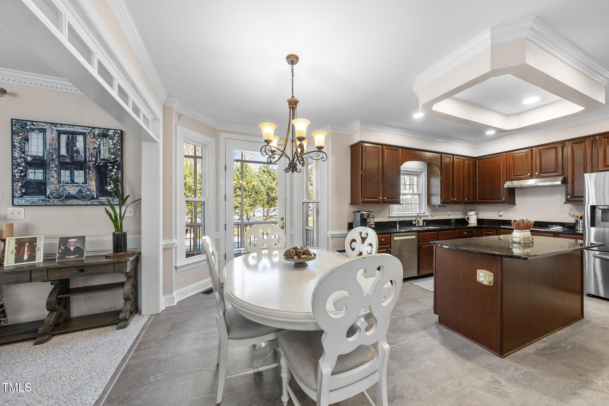 12016 Pembridge Lane Raleigh, NC 27613 - Photo 10 of 52 a kitchen with stove a refrigerator and chairs