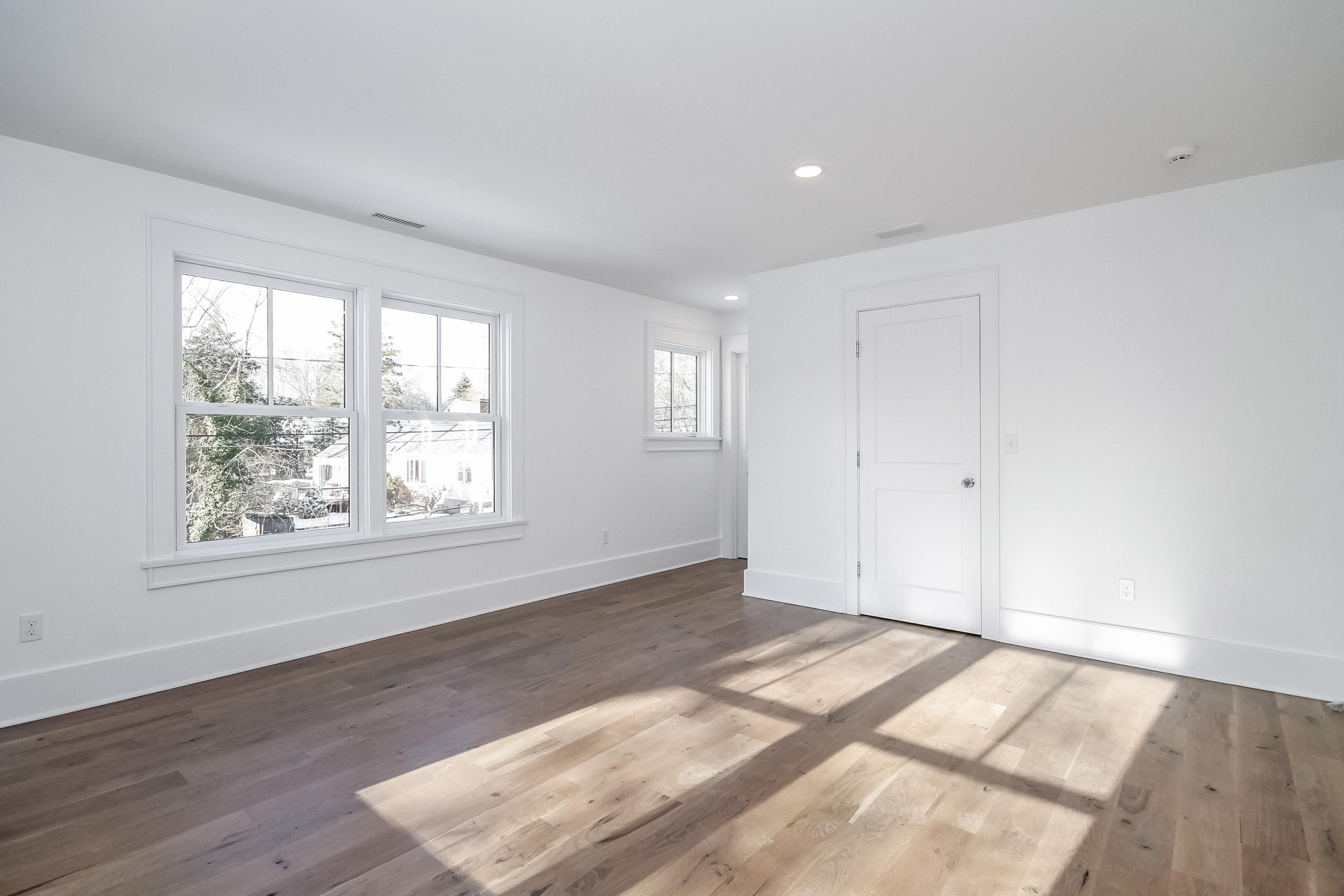 30 Relihan Road Darien, CT 06820 - Photo 29 of 47 an empty room with wooden floor and windows