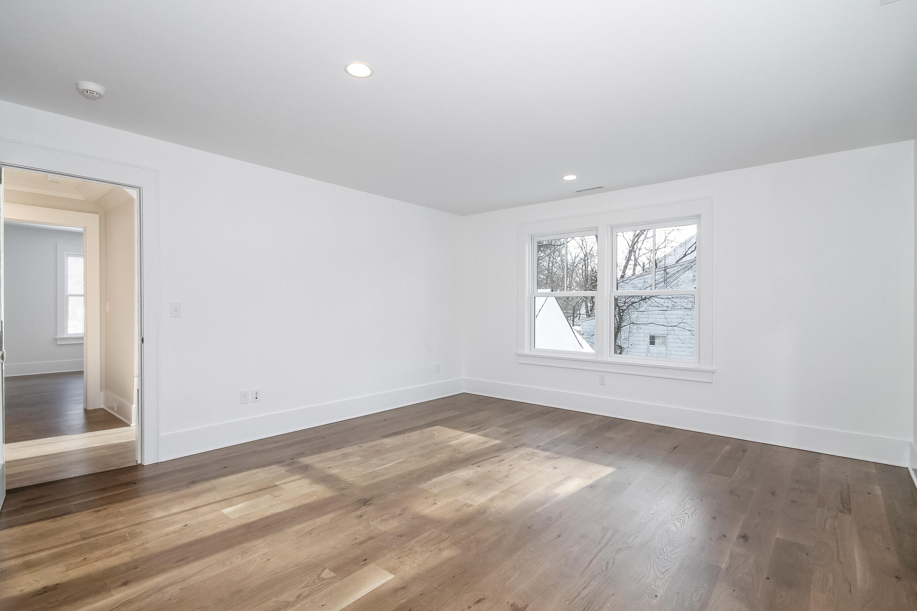 30 Relihan Road Darien, CT 06820 - Photo 30 of 47 an empty room with wooden floor and windows