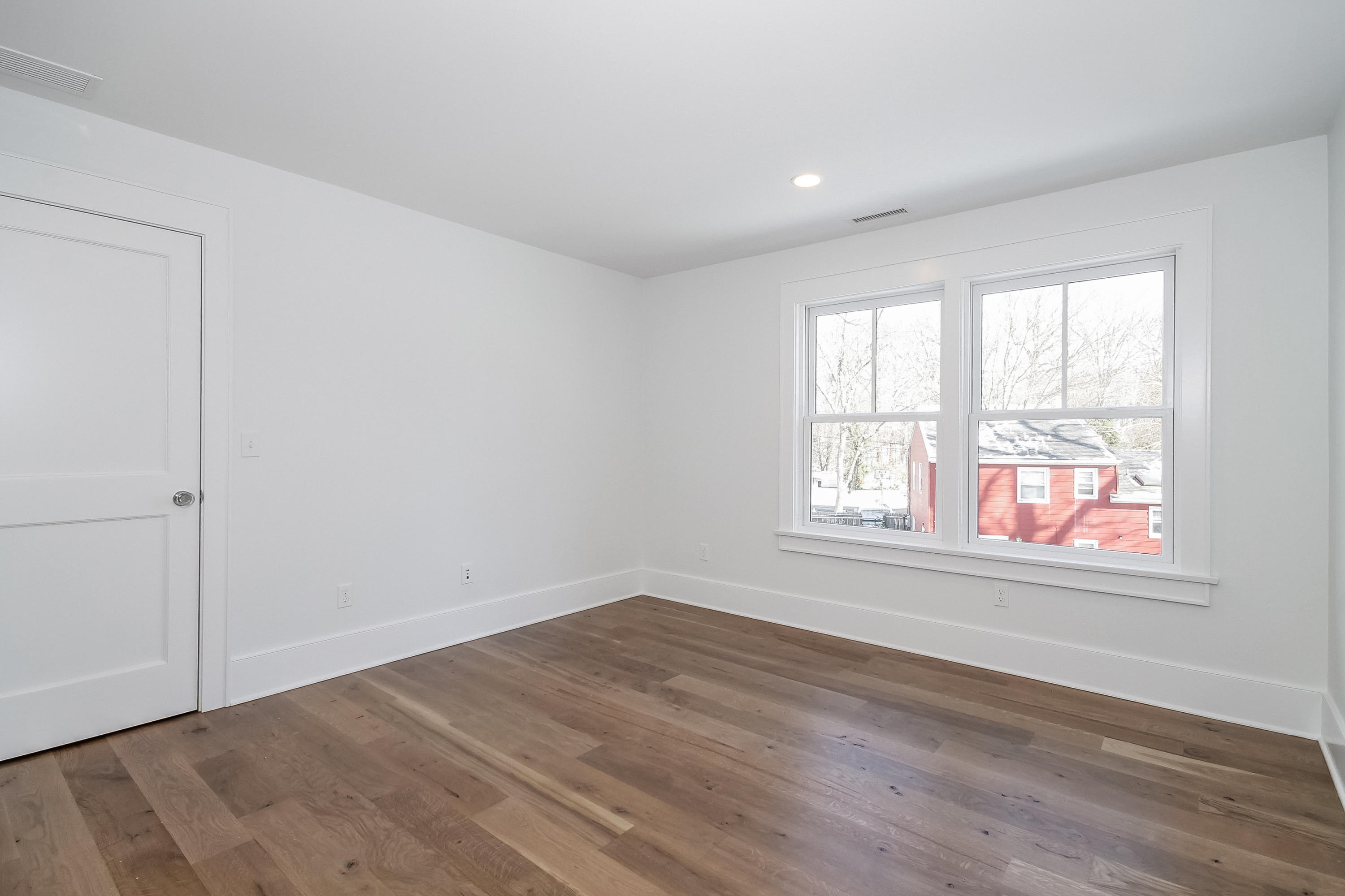 30 Relihan Road Darien, CT 06820 - Photo 31 of 47 an empty room with wooden floor and windows
