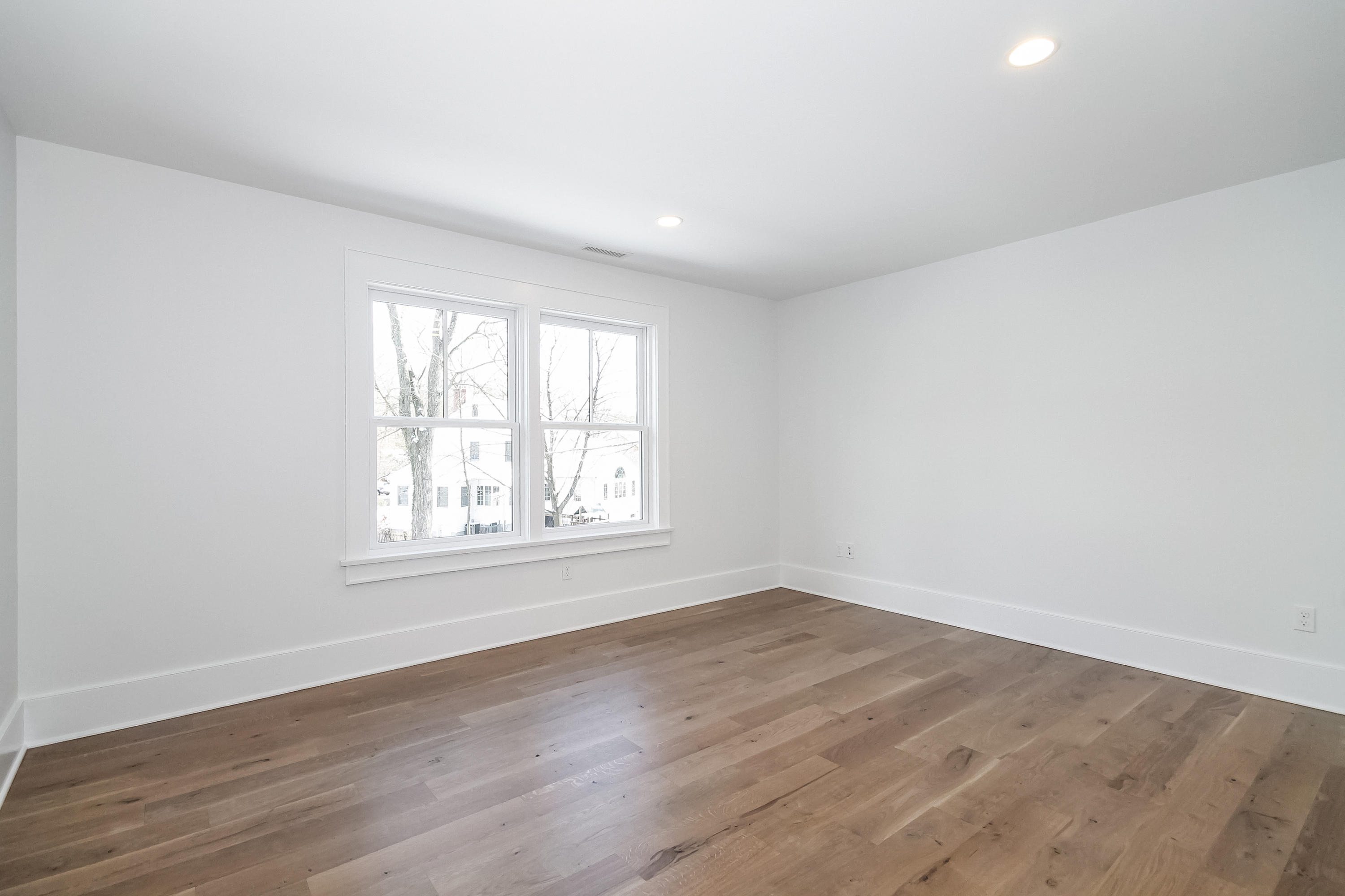 30 Relihan Road Darien, CT 06820 - Photo 32 of 47 an empty room with wooden floor and windows