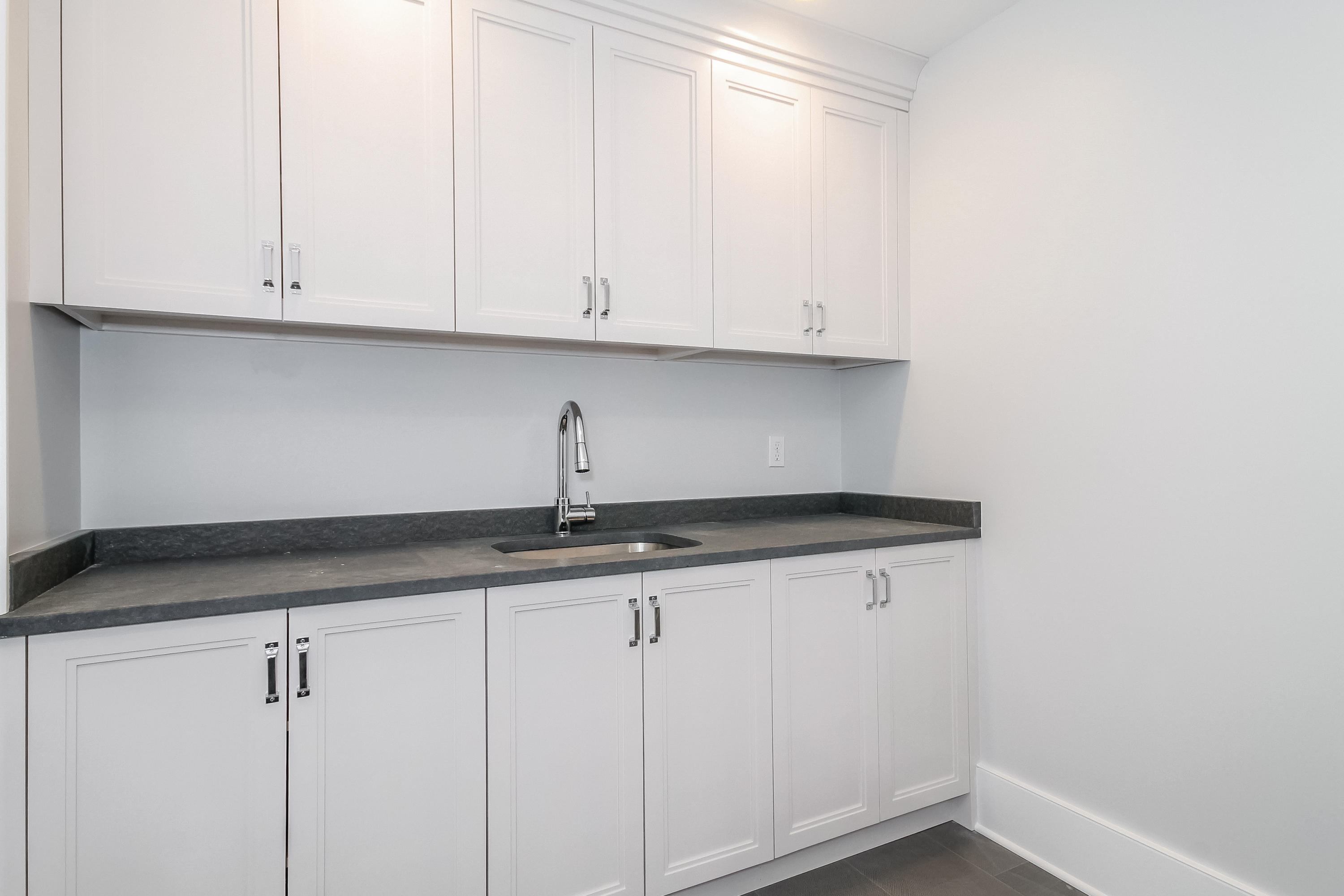 30 Relihan Road Darien, CT 06820 - Photo 34 of 47 a kitchen with granite countertop white cabinets and a sink