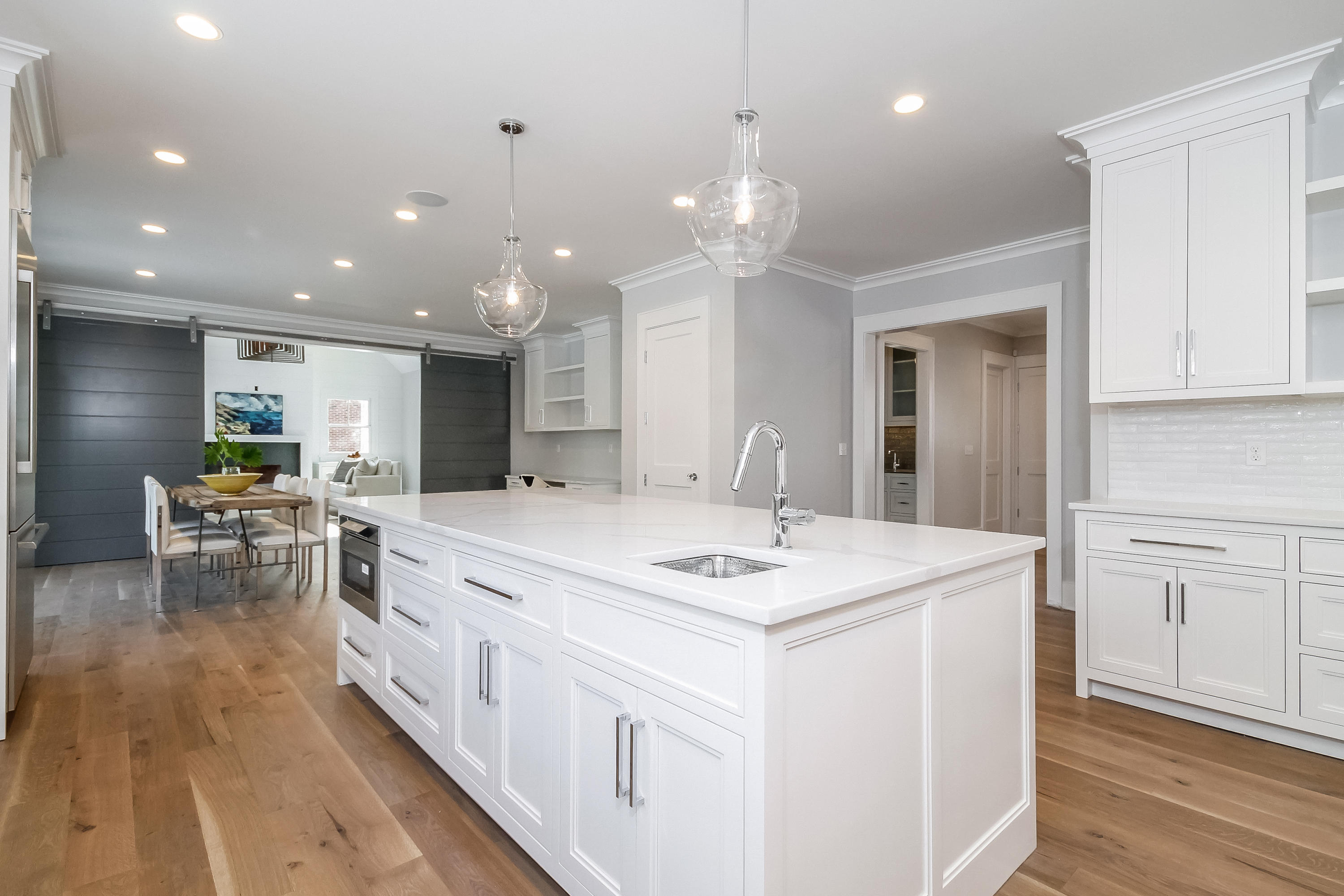 30 Relihan Road Darien, CT 06820 - Photo 7 of 47 a large white kitchen with kitchen island a sink table and chairs