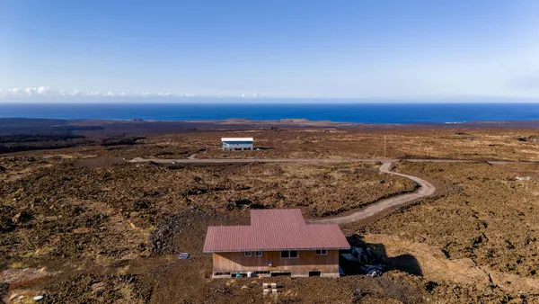 an aerial view of residential house with outdoor space