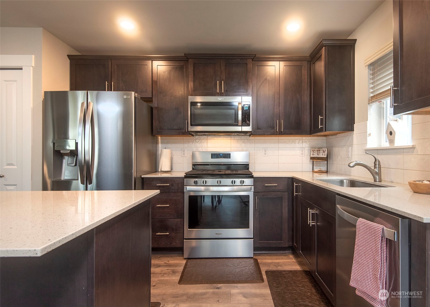 215 169th Place Southwest Bothell, WA 98012 - Photo 12 of 30 a kitchen with stainless steel appliances granite countertop a sink stove and refrigerator