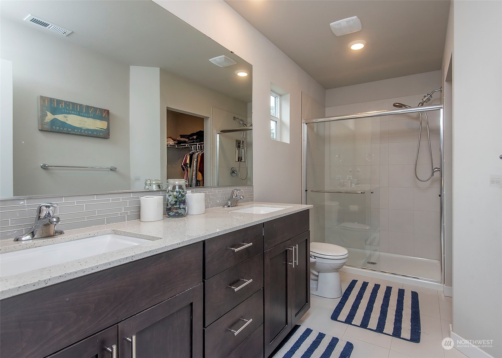 215 169th Place Southwest Bothell, WA 98012 - Photo 19 of 30 a bathroom with a sink a toilet a mirror and shower