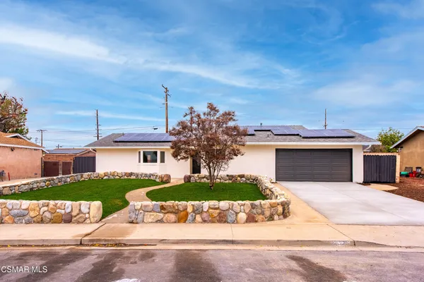 a view of a house with a yard and garage