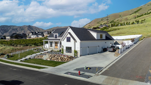 2013 South 100 West Perry, UT 84302 - Photo 40 of 49 Contemporary farmhouse-style residence featuring a prominent gable roofline and white vertical siding