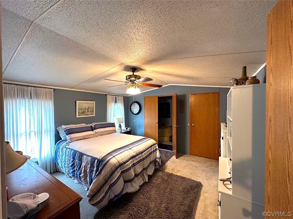 13504 Scotts Road Dewitt, VA 23840 - Photo 12 of 50 a bedroom with a large bed and a chandelier