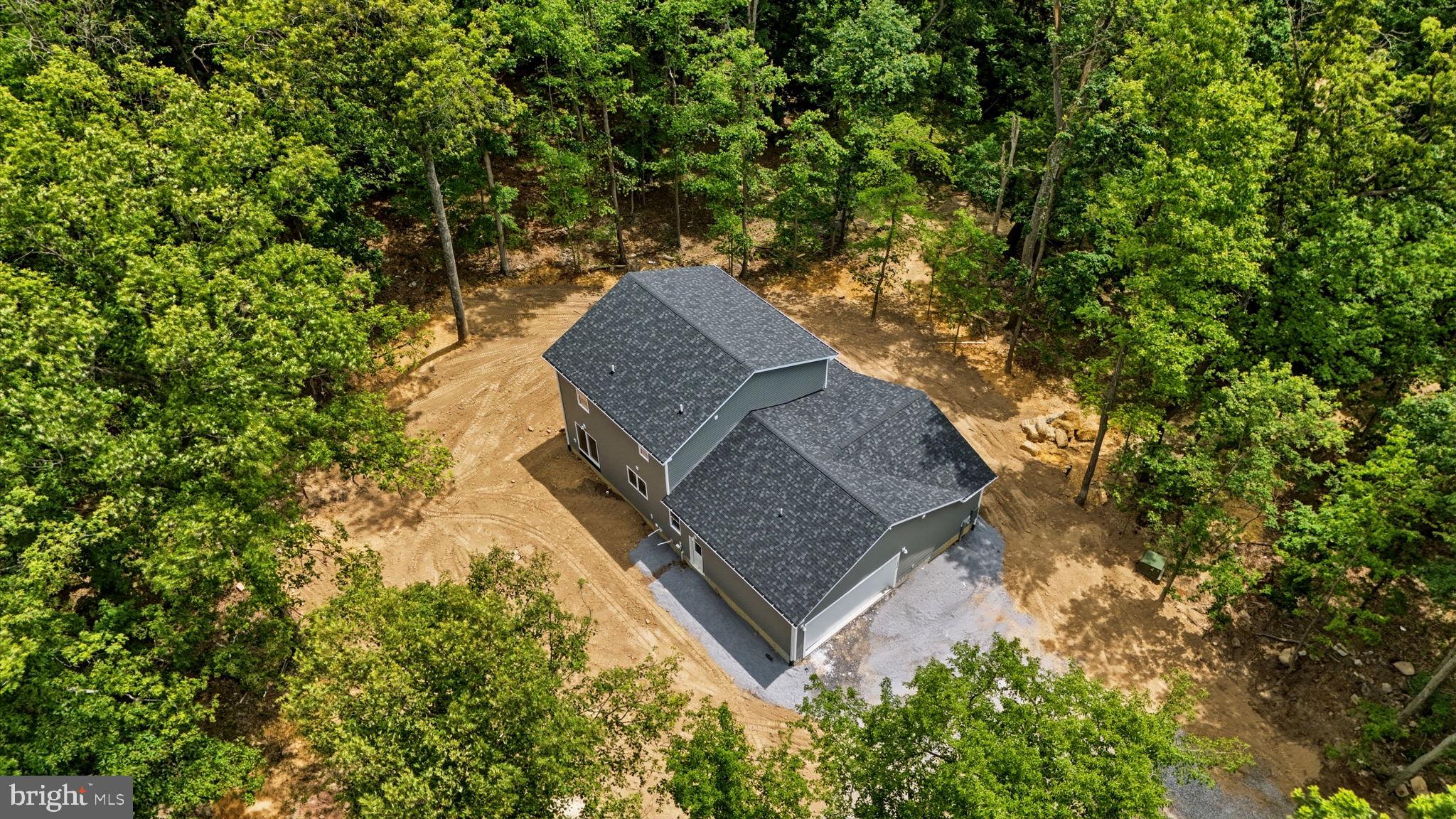 10339 Back Creek Valley Road Hedgesville, WV 25427 - Photo 47 of 48 a aerial view of a house with a yard and large trees