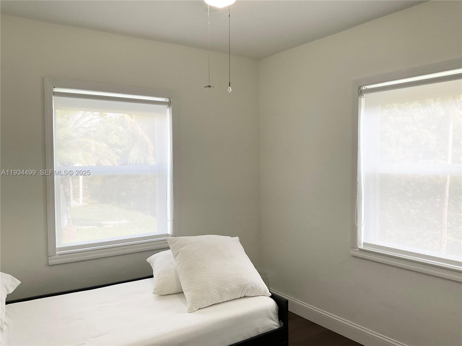 161 Northwest 145th Street Miami, FL 33168 - Photo 18 of 39 a bedroom with a bed and a window