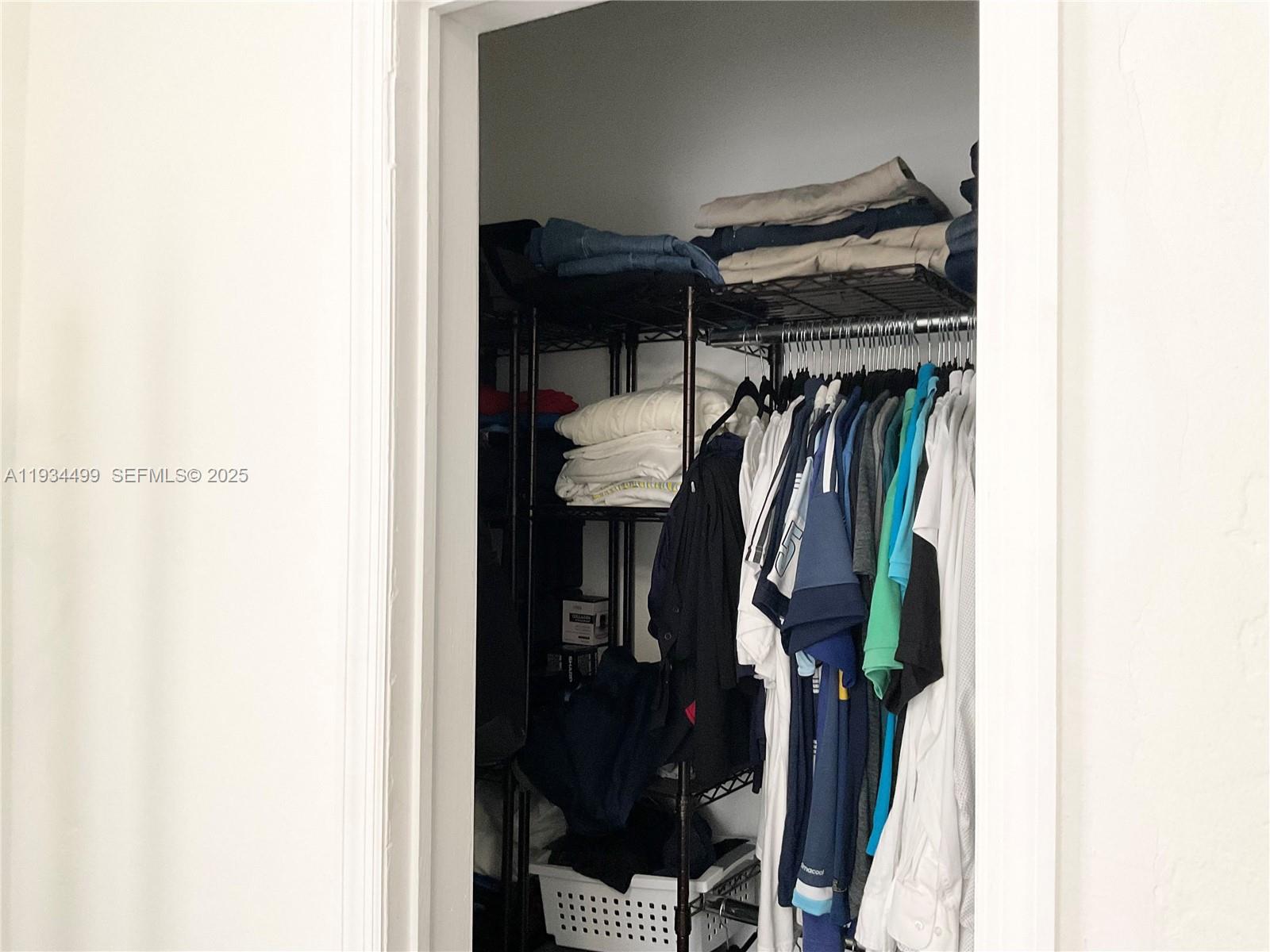 161 Northwest 145th Street Miami, FL 33168 - Photo 19 of 39 a view of walk in closet with clothes and shoes