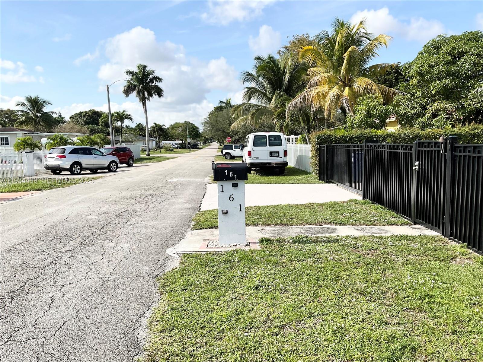 161 Northwest 145th Street Miami, FL 33168 - Photo 2 of 39 a view of a street with cars