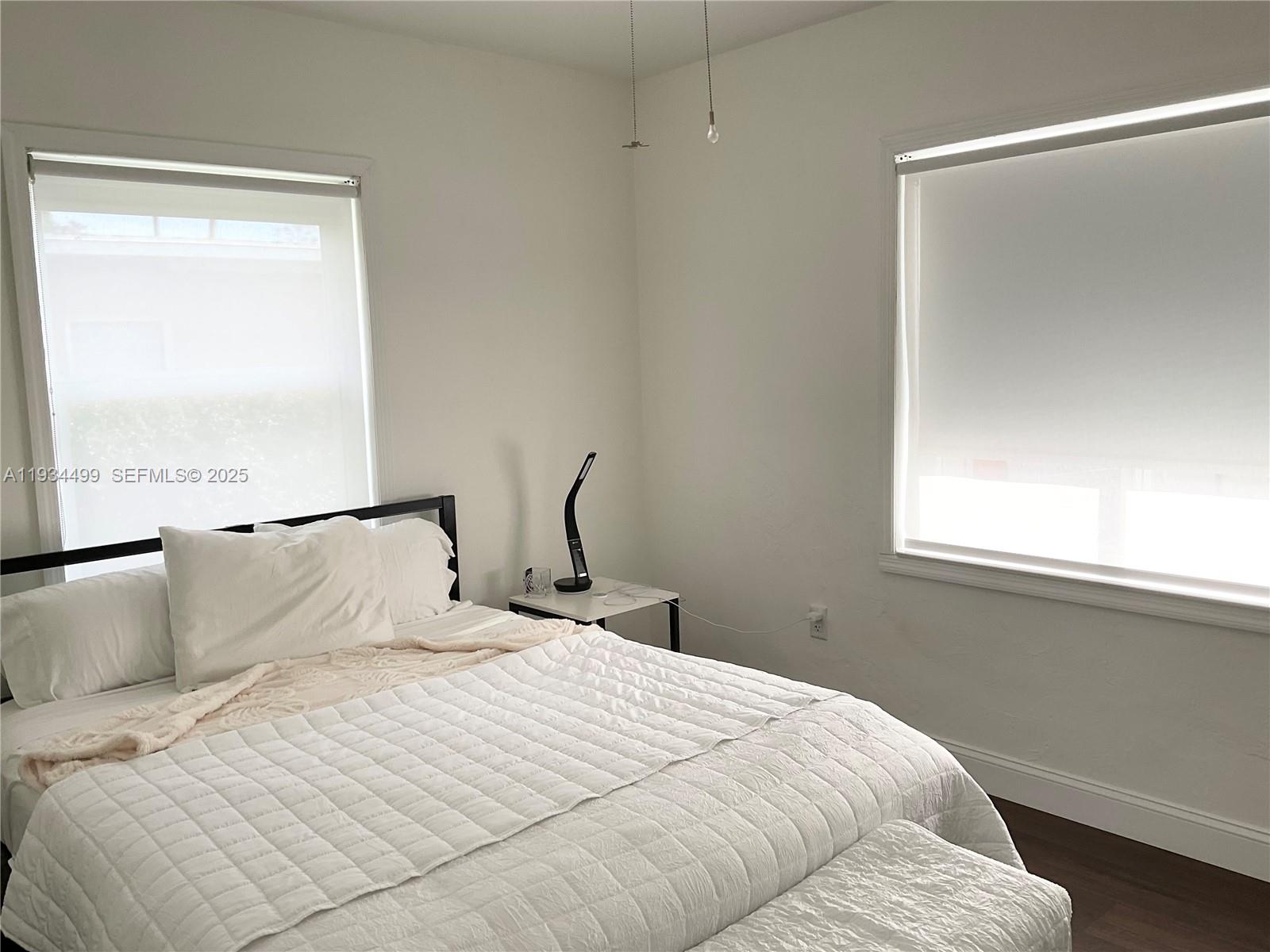 161 Northwest 145th Street Miami, FL 33168 - Photo 21 of 39 a bedroom with a bed and window