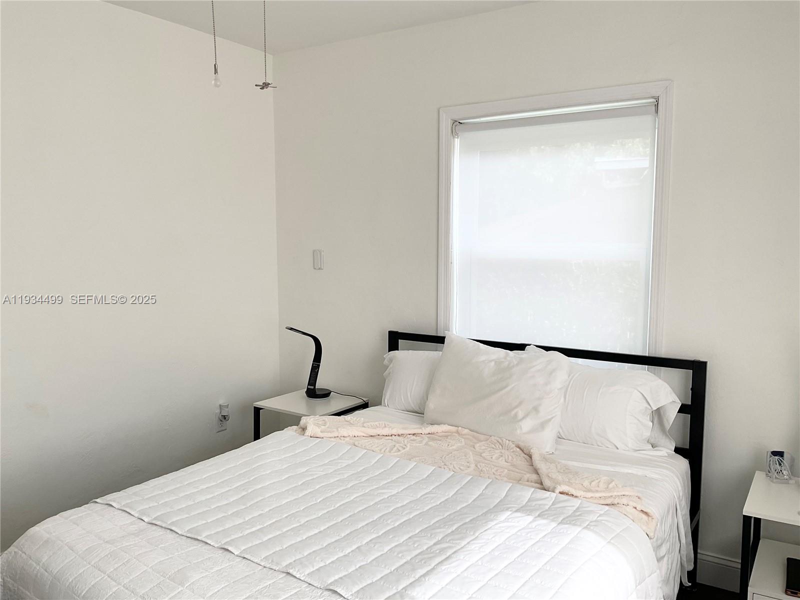 161 Northwest 145th Street Miami, FL 33168 - Photo 22 of 39 a bedroom with a bed and a window