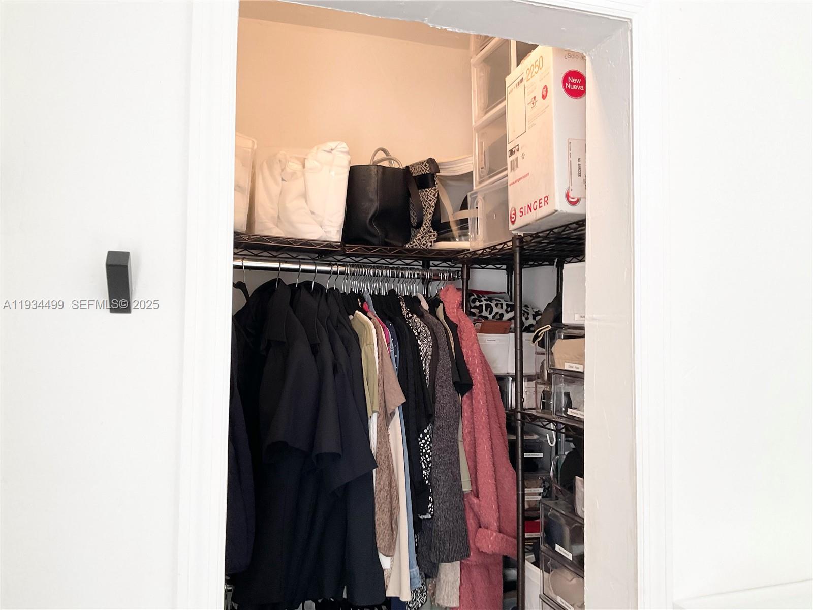 161 Northwest 145th Street Miami, FL 33168 - Photo 23 of 39 a view of walk in closet with clothes and shoes