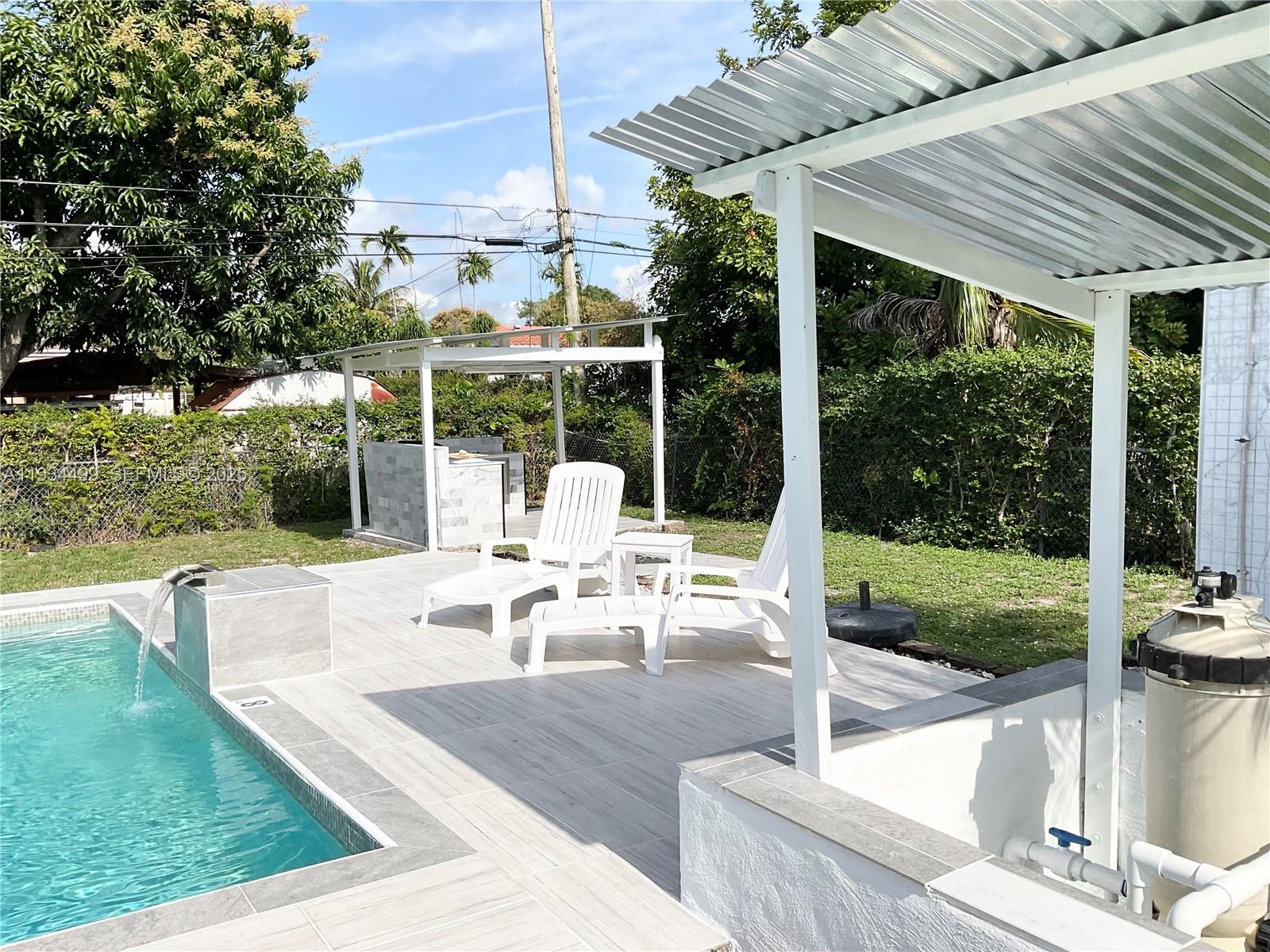 161 Northwest 145th Street Miami, FL 33168 - Photo 31 of 39 a view of a patio with couches chairs and large trees