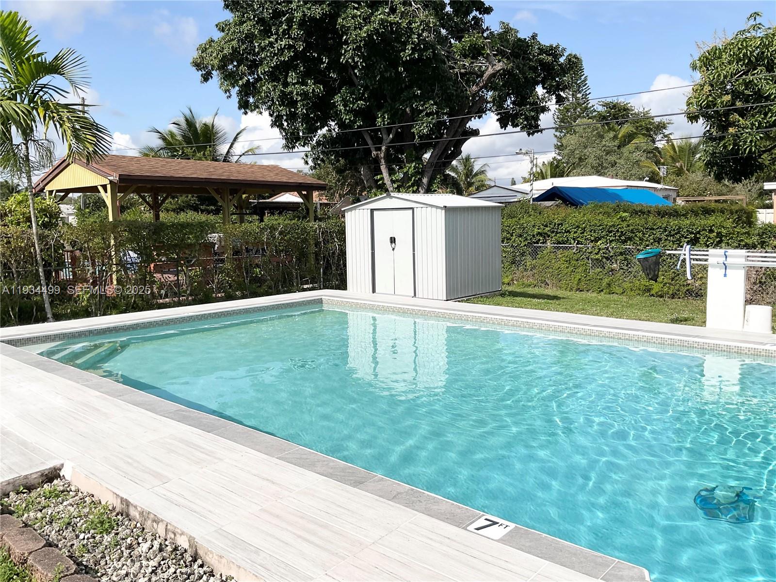 161 Northwest 145th Street Miami, FL 33168 - Photo 33 of 39 a front view of a house with a yard