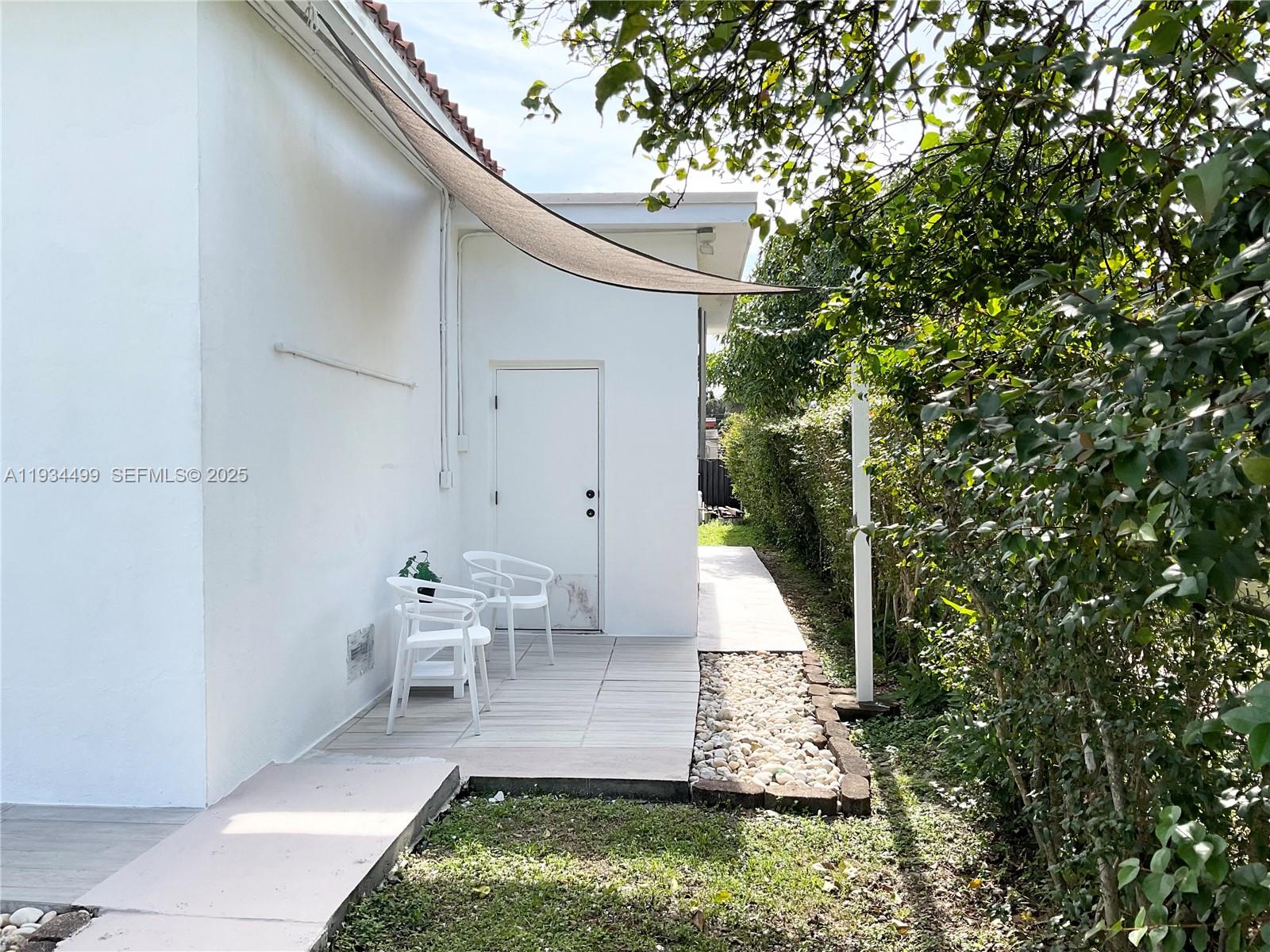 161 Northwest 145th Street Miami, FL 33168 - Photo 35 of 39 a backyard of a house with outdoor seating