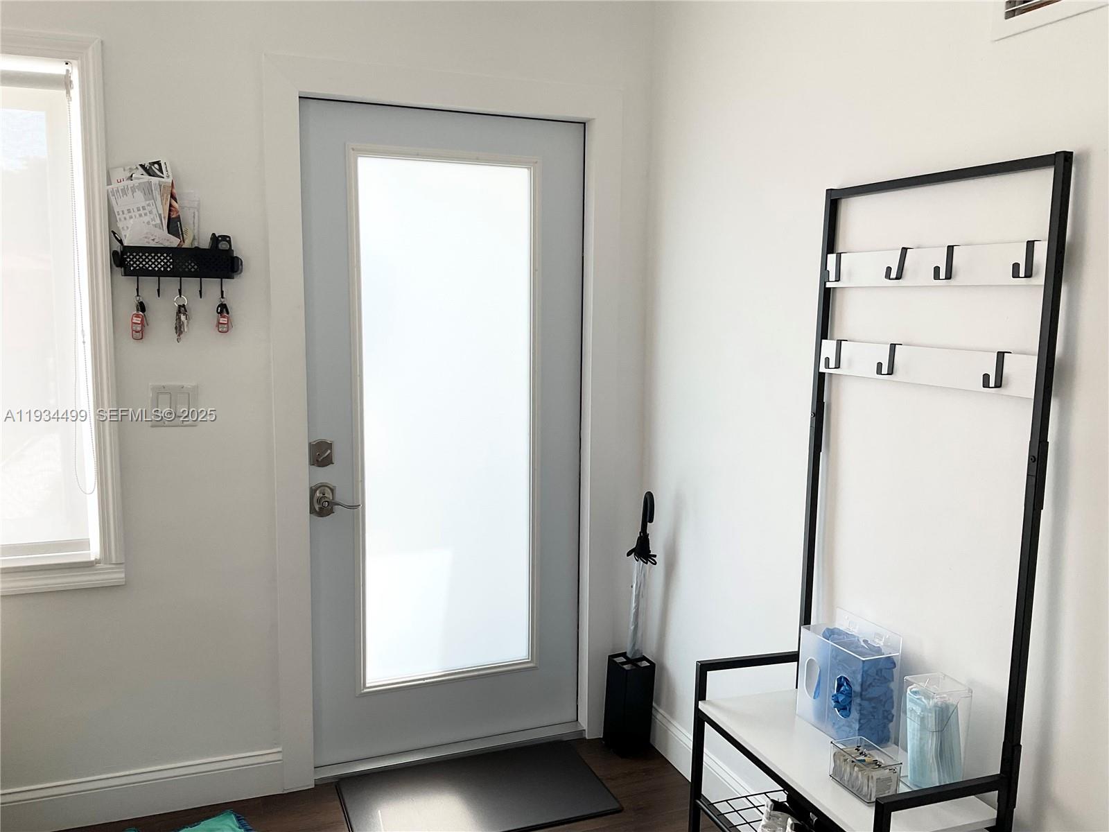 161 Northwest 145th Street Miami, FL 33168 - Photo 4 of 39 a view of a room with rack on the wall and a window