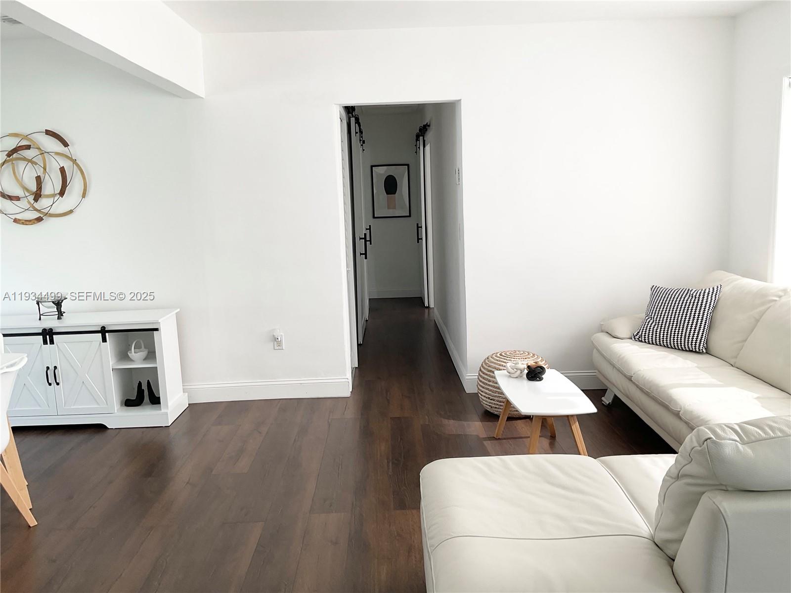 161 Northwest 145th Street Miami, FL 33168 - Photo 6 of 39 a living room with furniture and a wooden floor