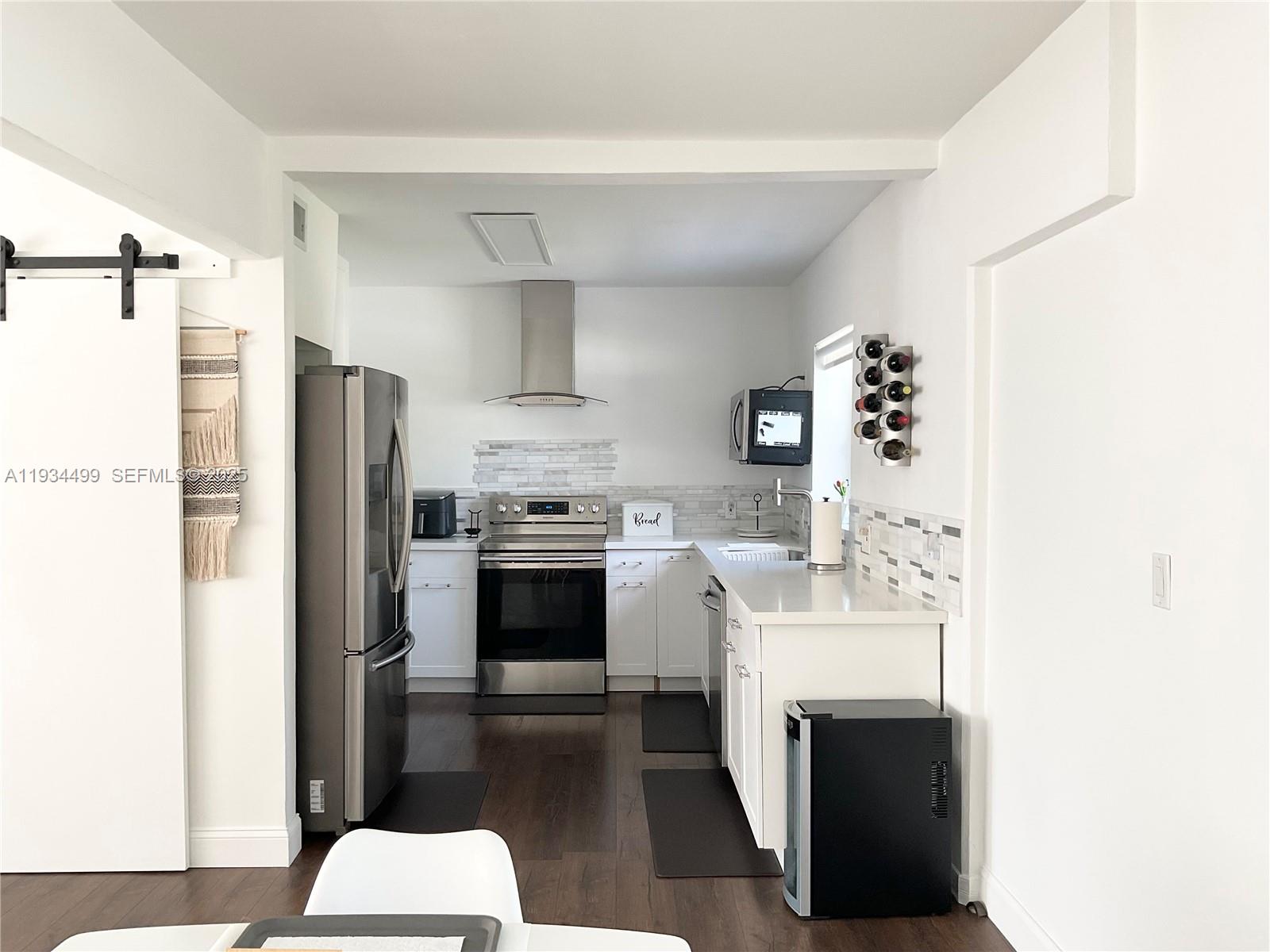 161 Northwest 145th Street Miami, FL 33168 - Photo 8 of 39 a kitchen with cabinets and steel stainless steel appliances