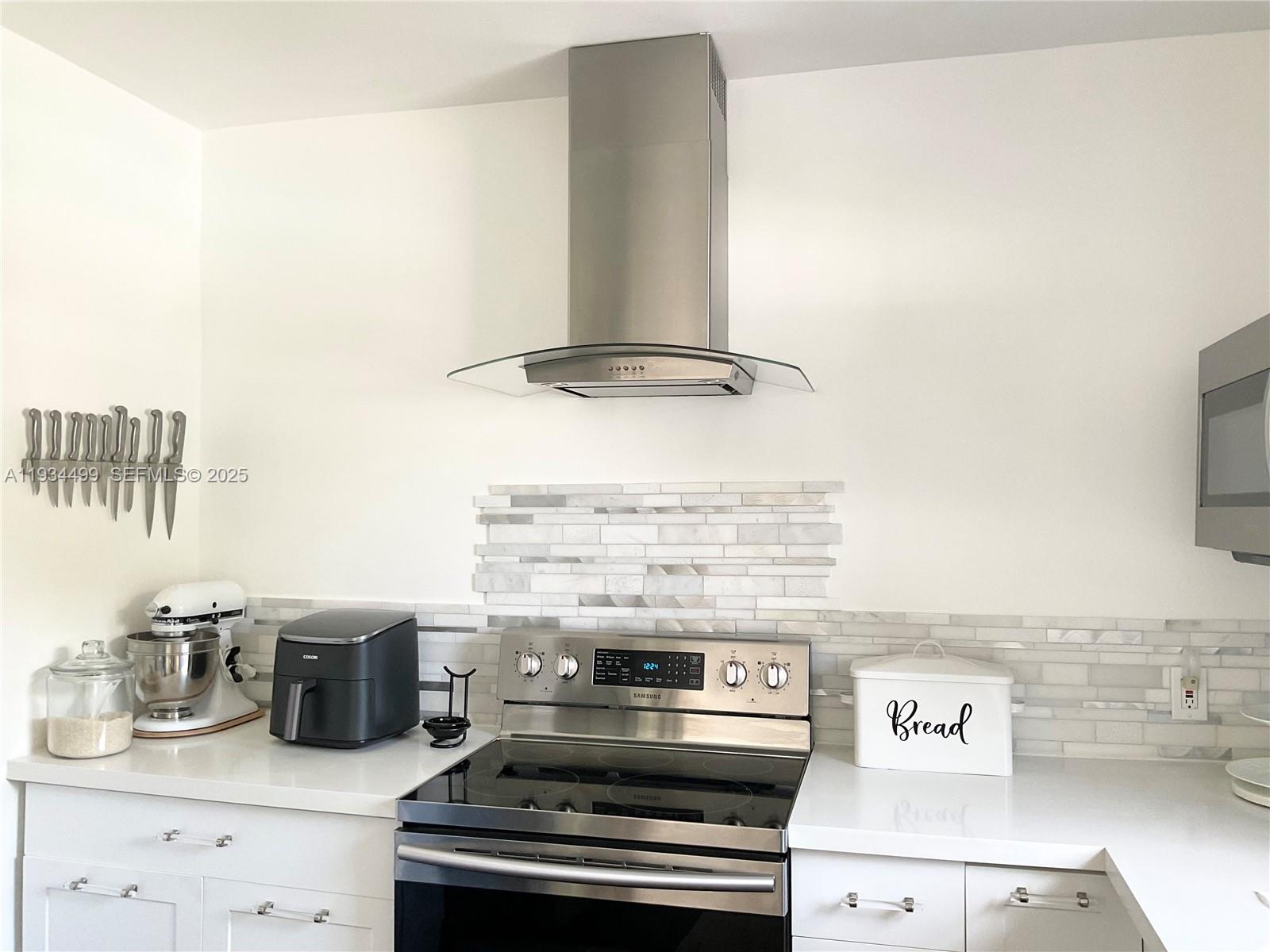 161 Northwest 145th Street Miami, FL 33168 - Photo 9 of 39 a kitchen with a stove and cabinets