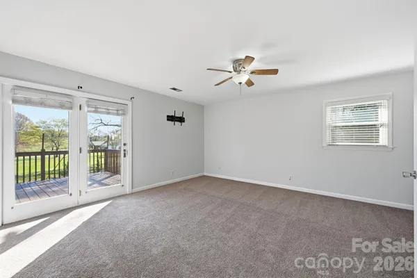 a view of a livingroom with a ceiling fan and window