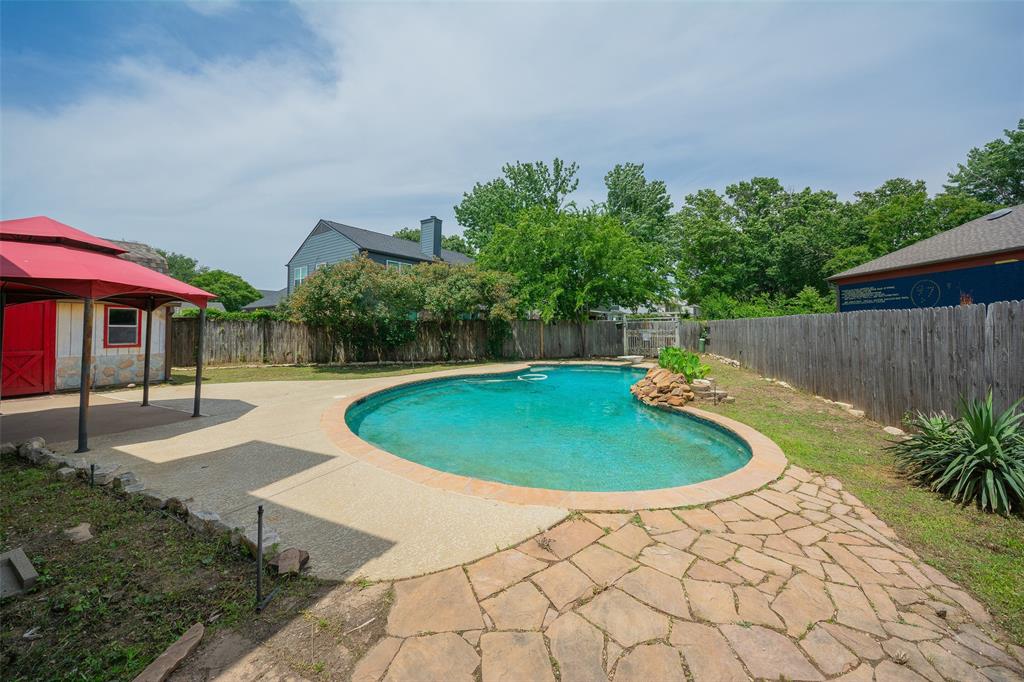 716 Bridget Way Hurst, TX 76054 - Photo 17 of 19 a view of a backyard with a small pool and plants
