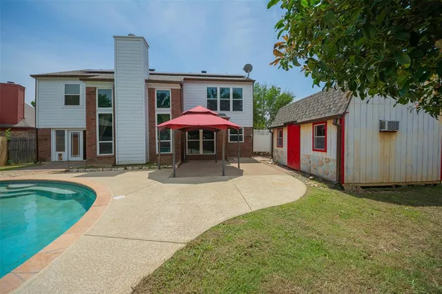 a view of a house with a yard and sitting area