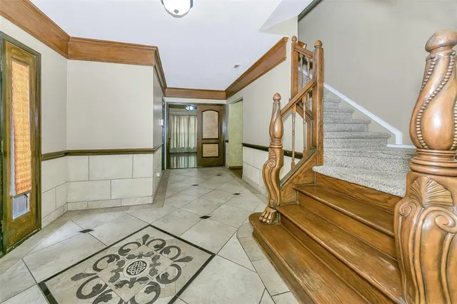 a view of staircase with wooden floor and a rug