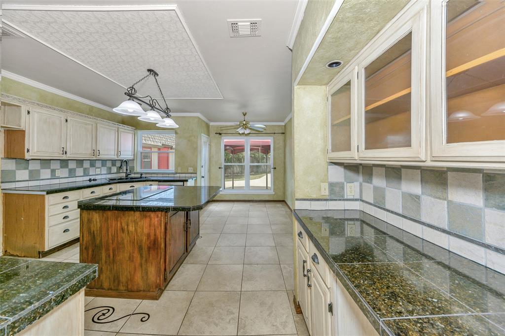716 Bridget Way Hurst, TX 76054 - Photo 7 of 19 a kitchen with granite countertop a sink a counter space appliances and cabinets