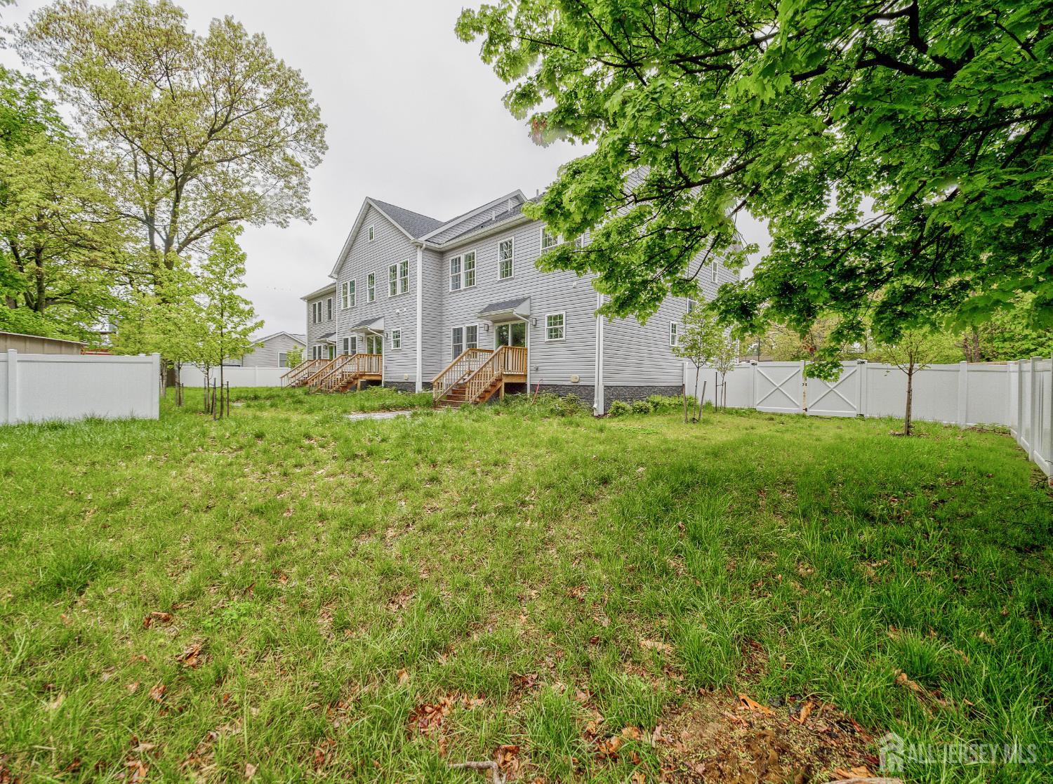 8 Travers Avenue, Unit 1 Edison, NJ 08817 - Photo 18 of 19 a view of a house with a big yard and large trees