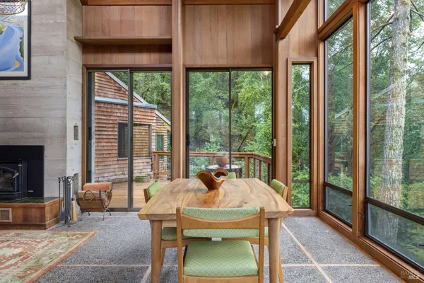 a view of a patio with a table chairs and a backyard