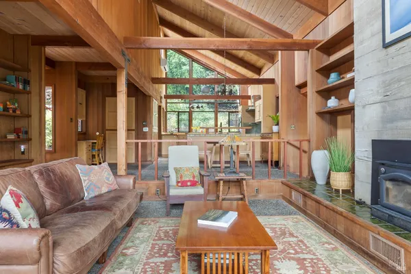 a living room with furniture a flat screen tv and a fireplace
