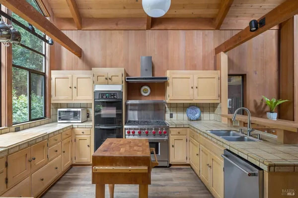 a kitchen with cabinets and window