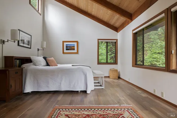 a bedroom with a large bed and a window