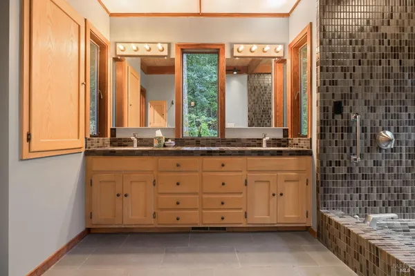 a bathroom with a granite countertop sink and a mirror