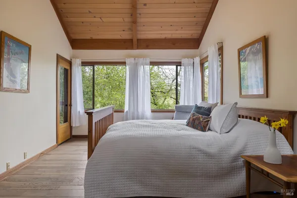 a bedroom with a large bed and a large window