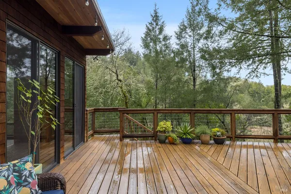 a view of balcony with wooden floor and outdoor seating