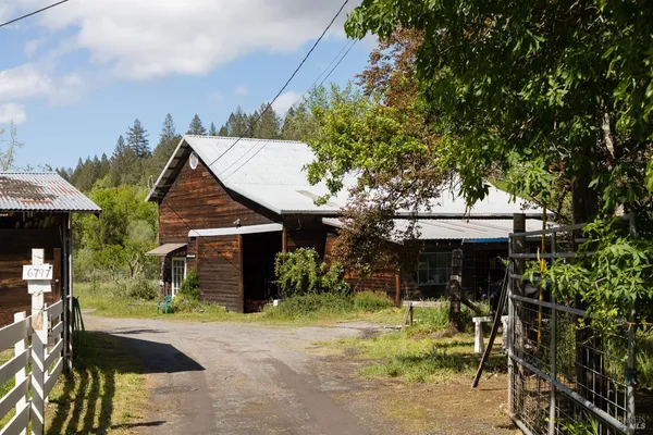 a view of a house with backyard porch and sitting area